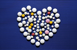 A heart made out of pills on a blue background