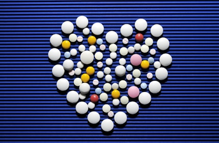 A heart made out of pills on a blue background