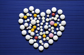 A heart made out of pills on a blue background