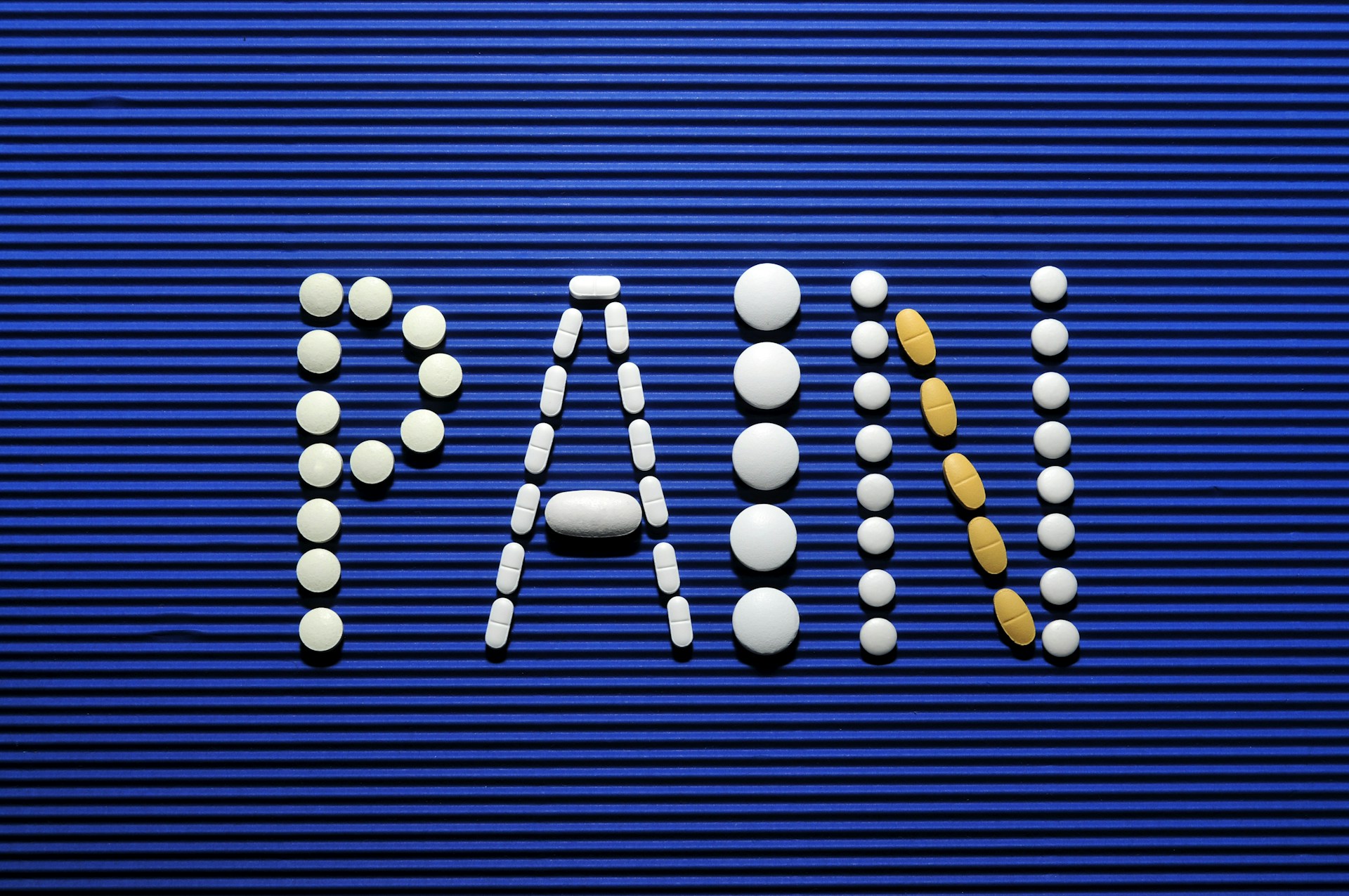 The word war spelled out of pills on a blue background