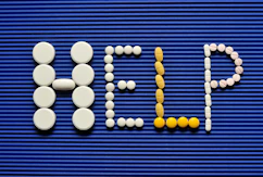 Pills spelling out the word pill pill on a blue background