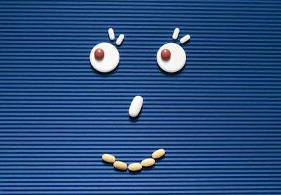 A sad face made out of pills on a blue background