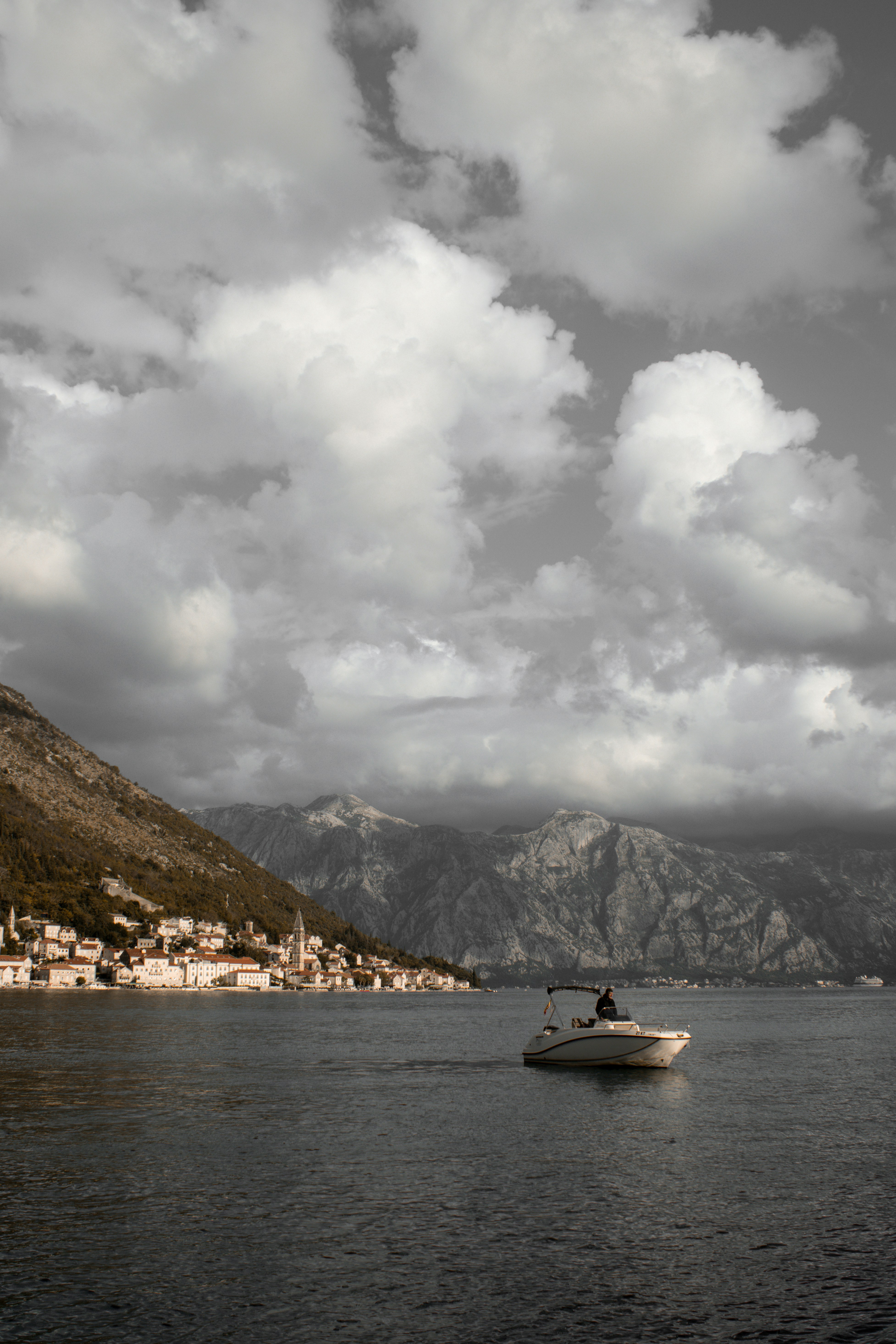 A boat is in the water with a mountain in the background