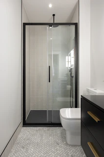 A bathroom with a toilet, sink, and shower
