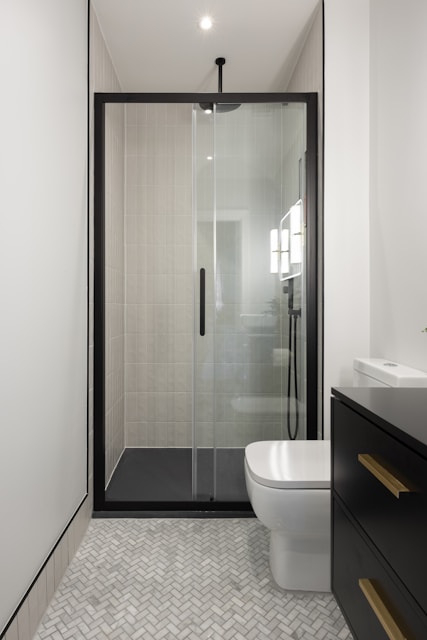 A bathroom with a toilet, sink, and shower