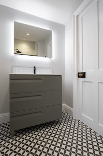 A bathroom with a black and white checkered floor