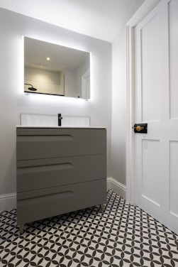 A bathroom with a black and white checkered floor