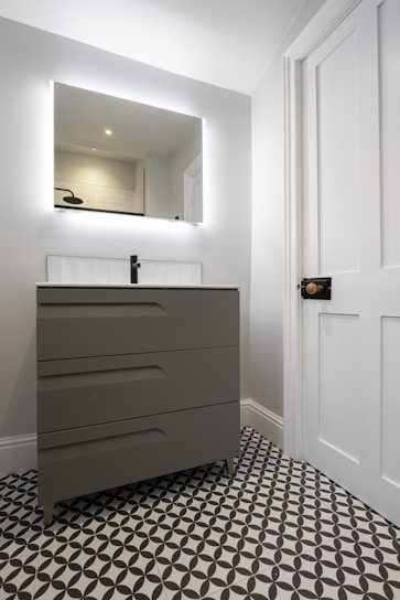 A bathroom with a black and white checkered floor