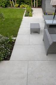 A patio with a table, chairs and umbrella