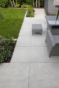A patio with a table, chairs and umbrella