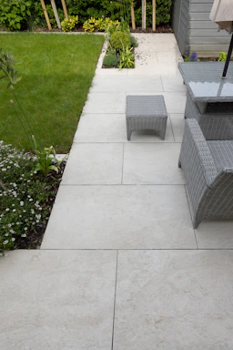 A patio with a table, chairs and umbrella
