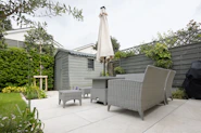 A patio with a table and chairs and an umbrella