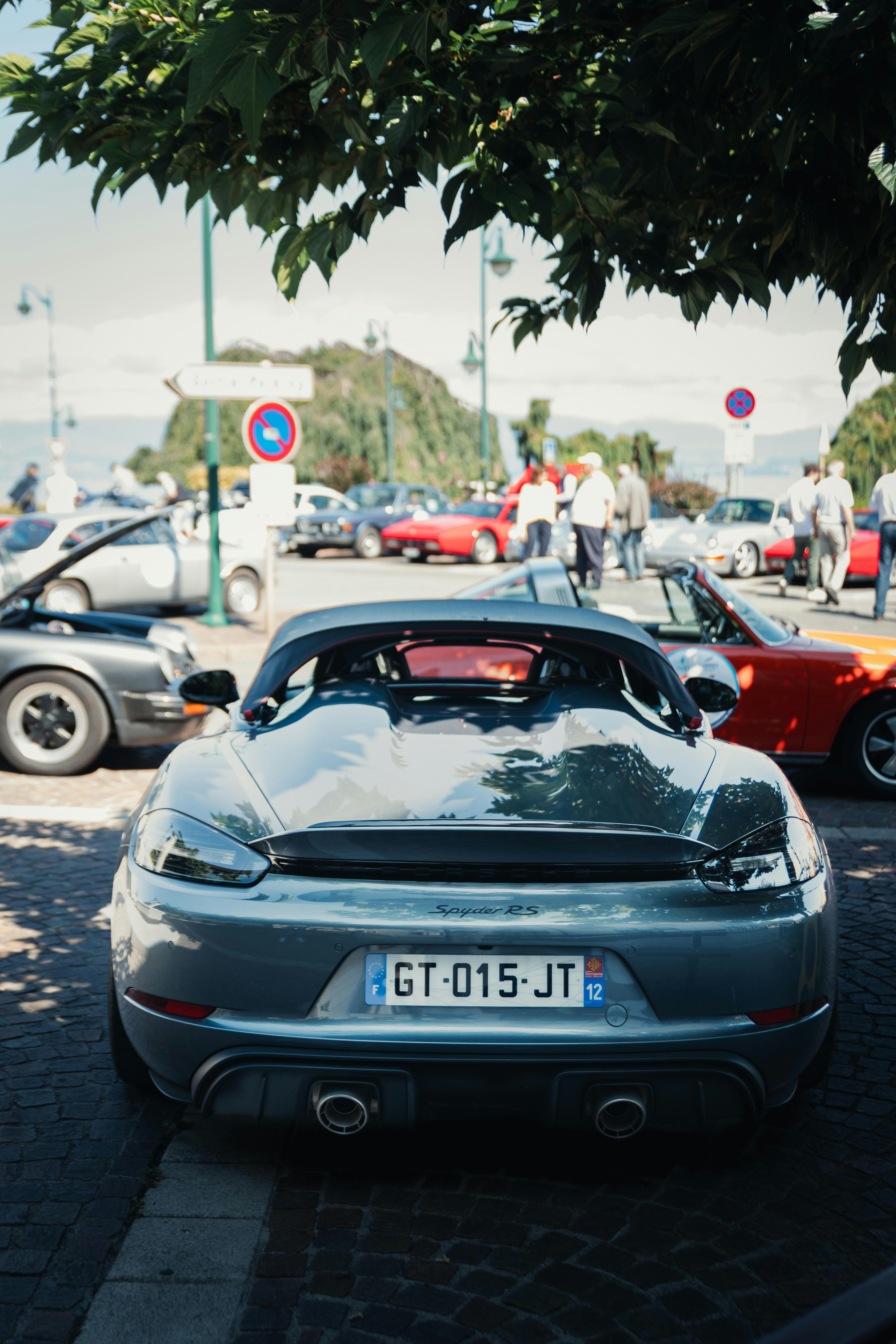 A silver sports car parked on the side of the road
