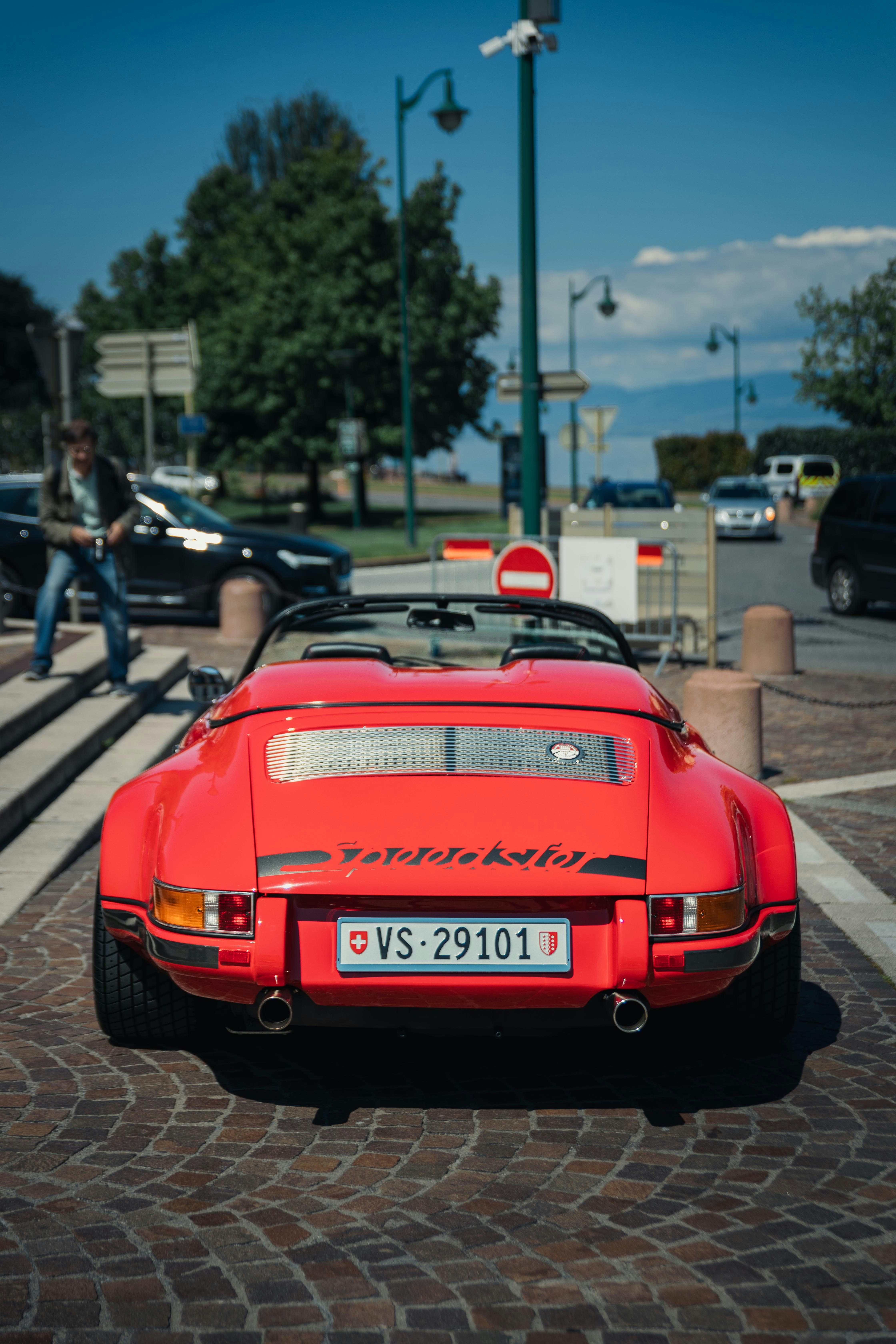 A red sports car parked in a parking lot