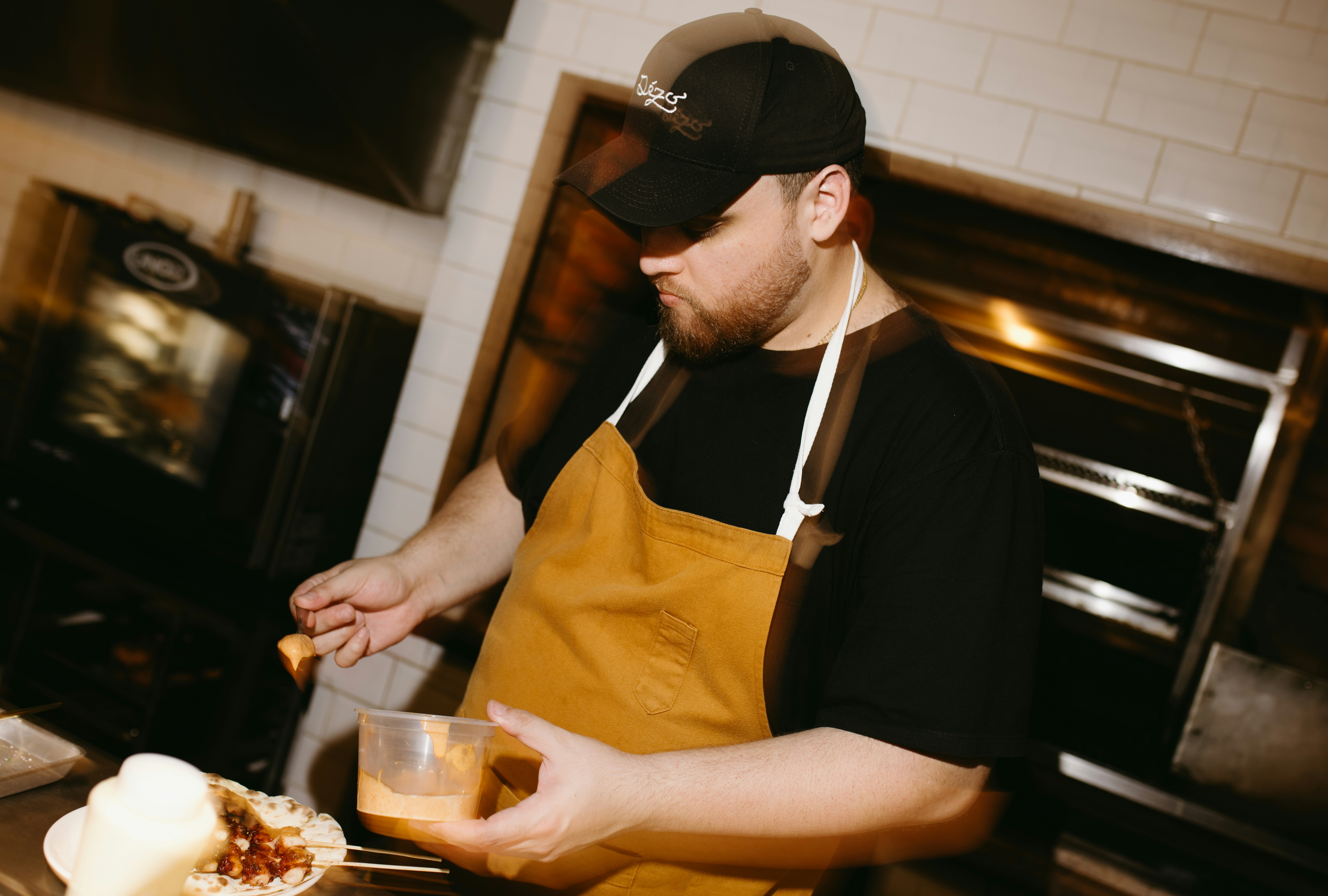Chef in cap and apron preparing food in a restaurant kitchen