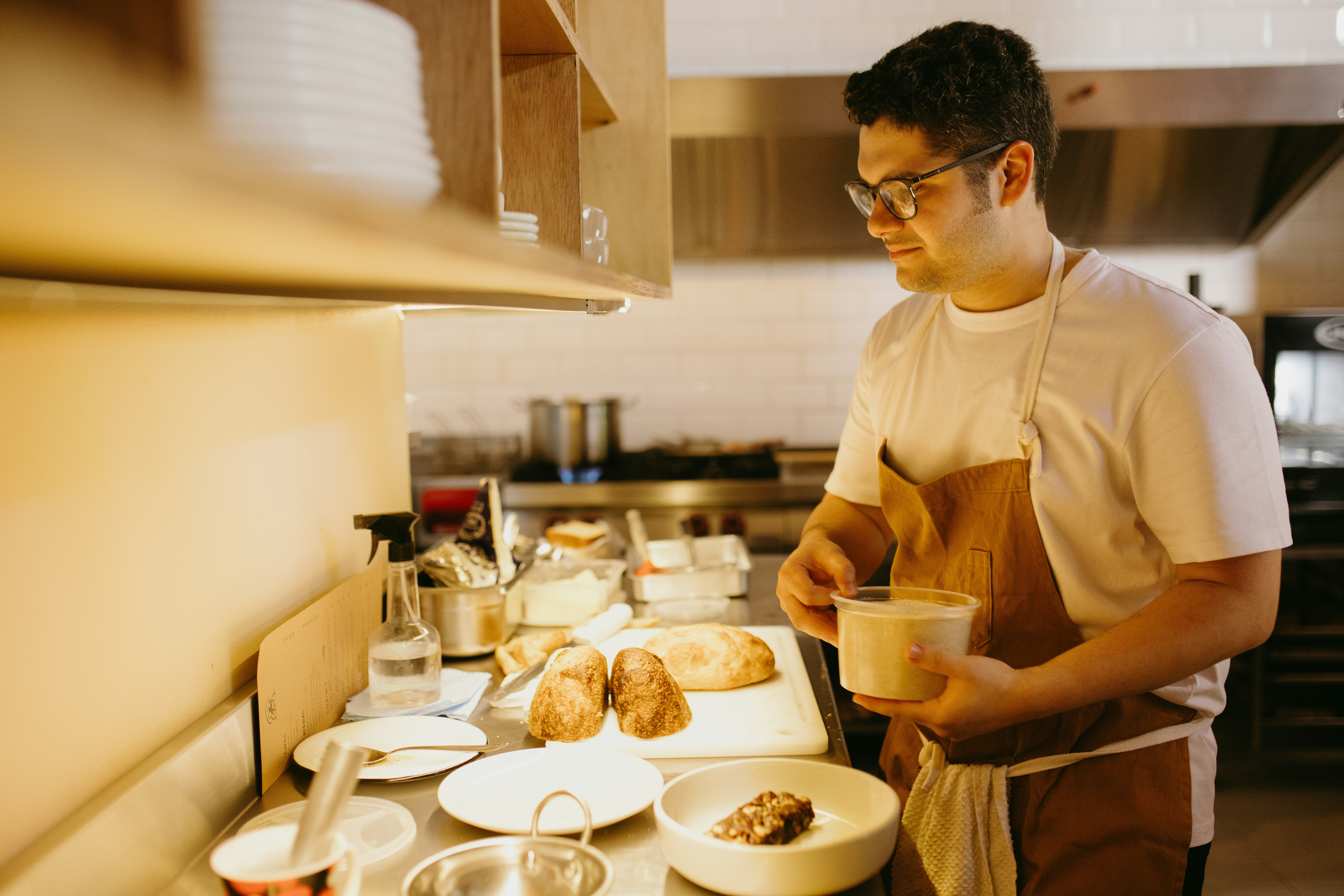 A man standing in a kitchen preparing food