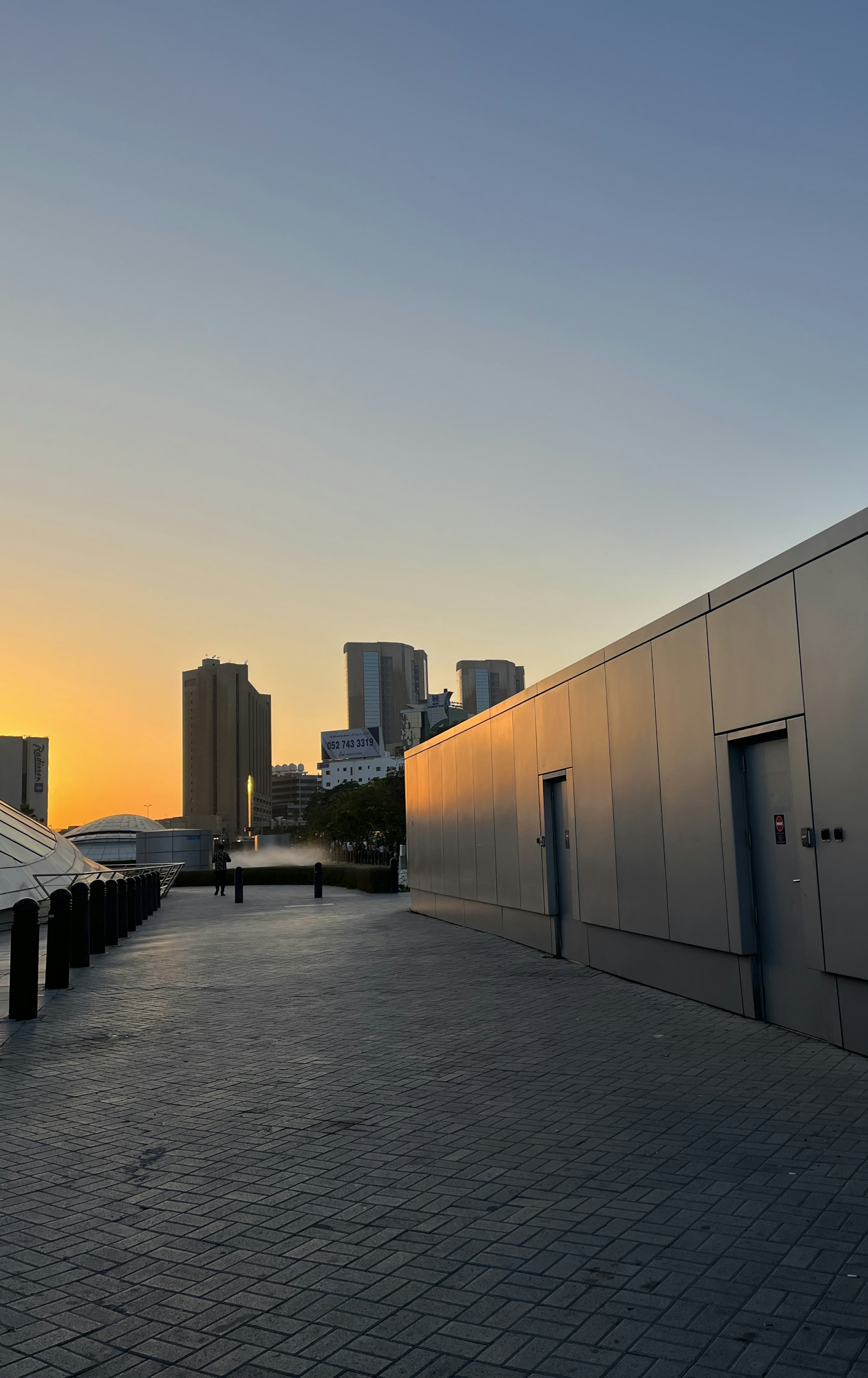 The sun is setting on a city street