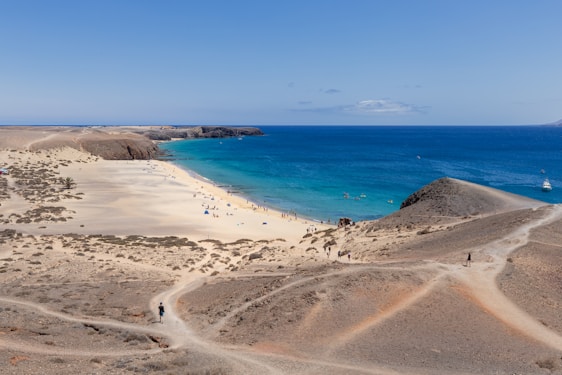 A sandy beach next to a blue ocean