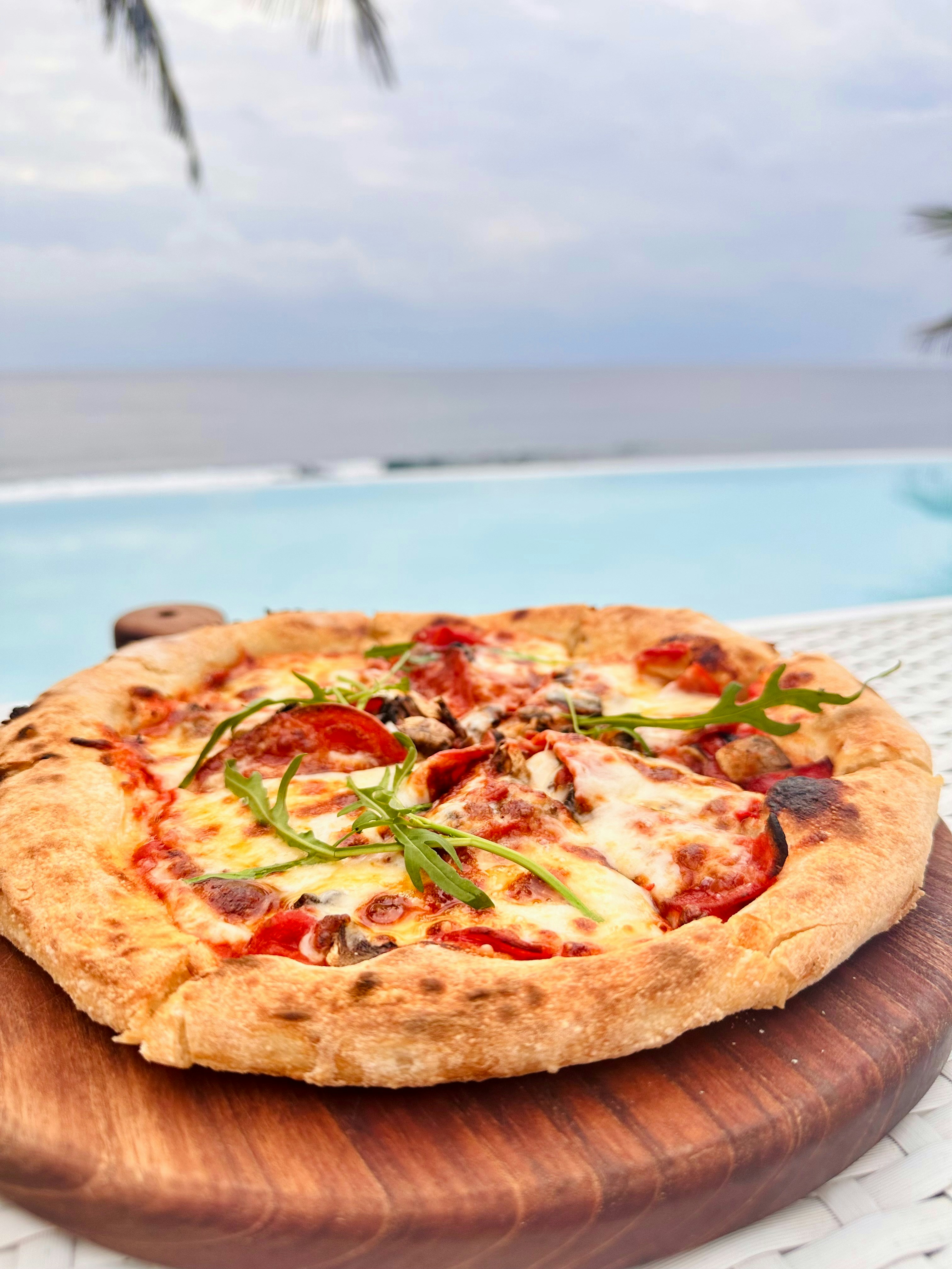 A pizza sitting on top of a wooden cutting board