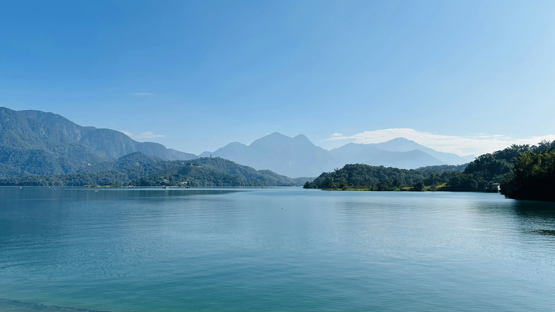A body of water with mountains in the background