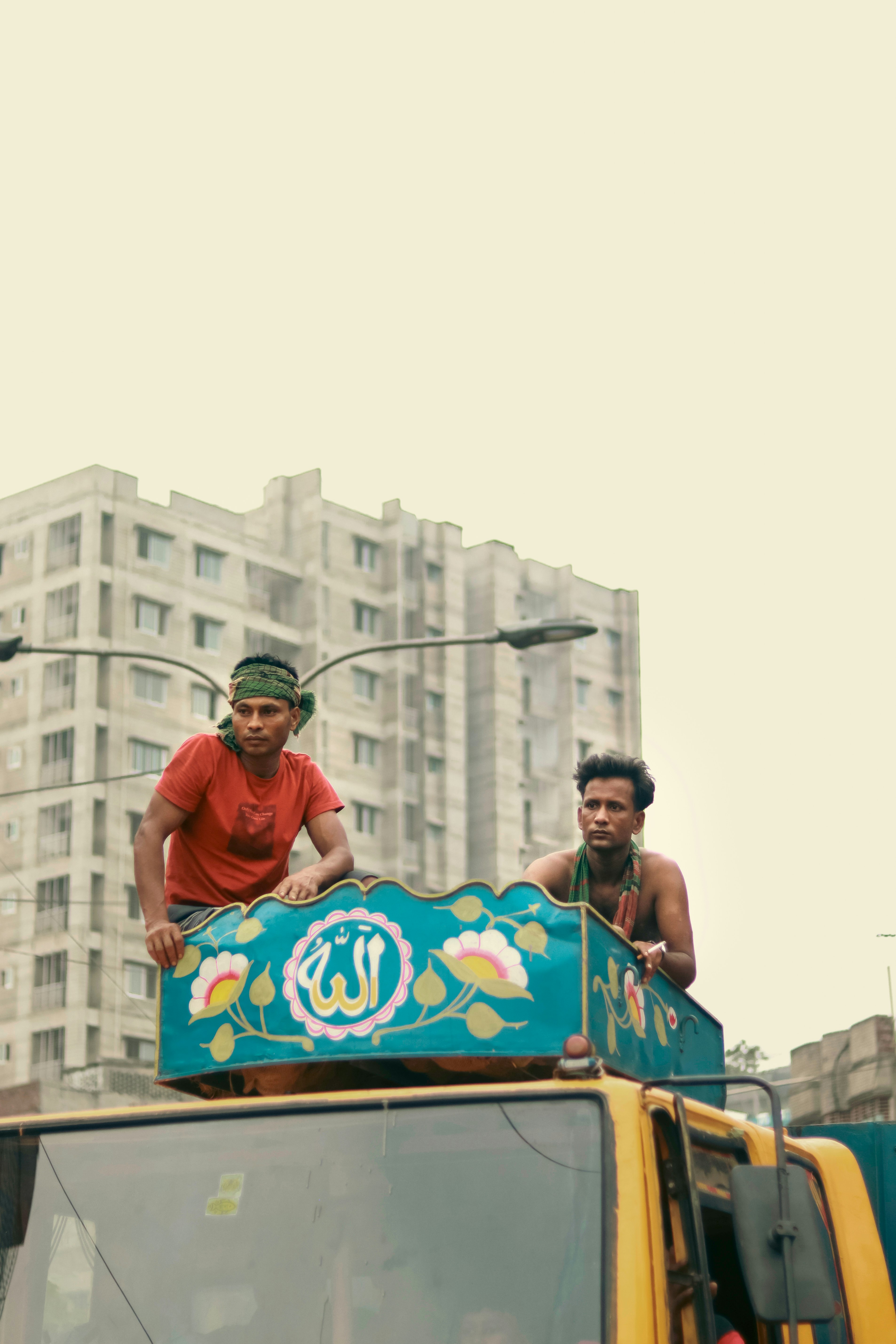 A group of men standing on top of a bus