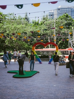 A group of people walking around a park