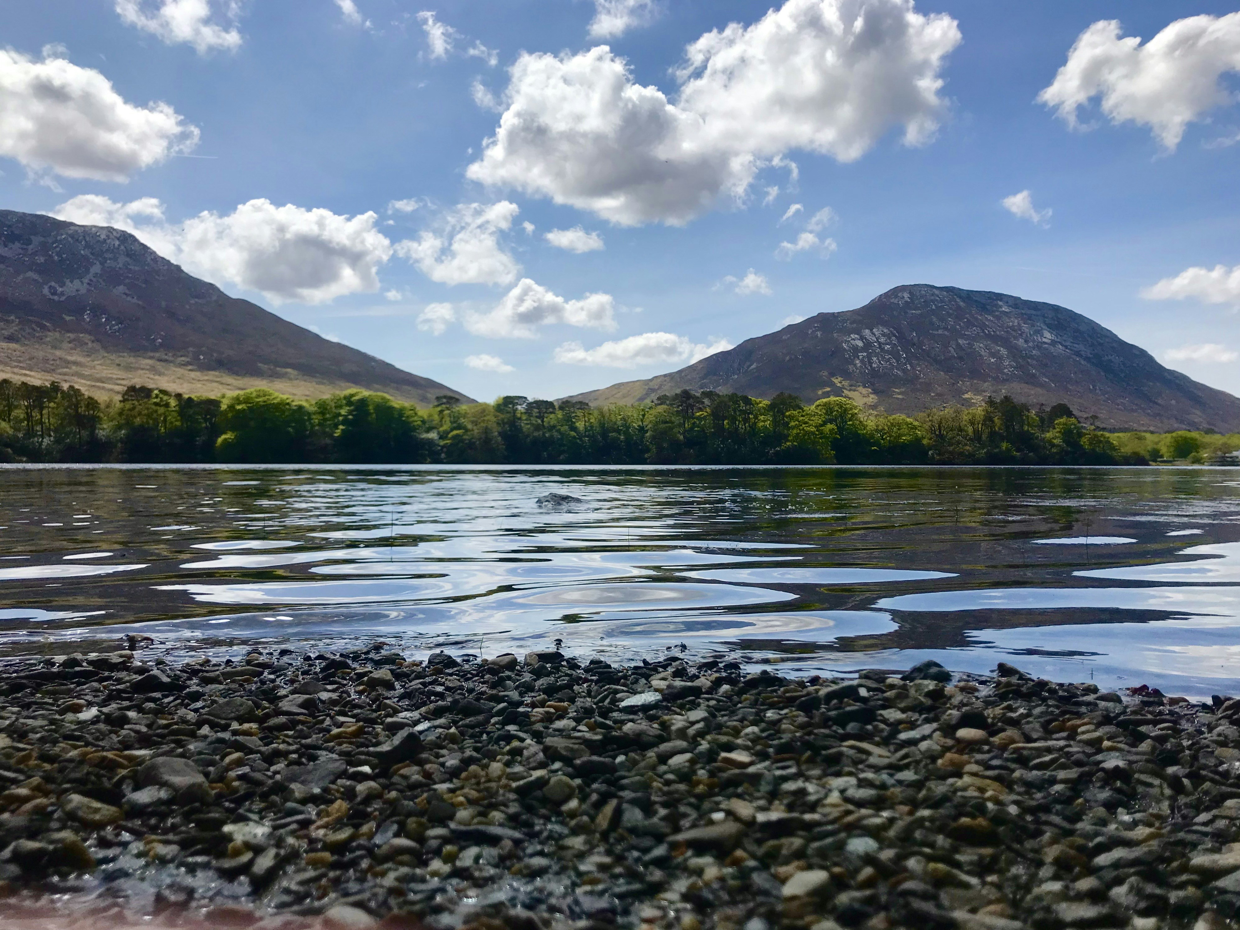 A body of water with mountains in the background