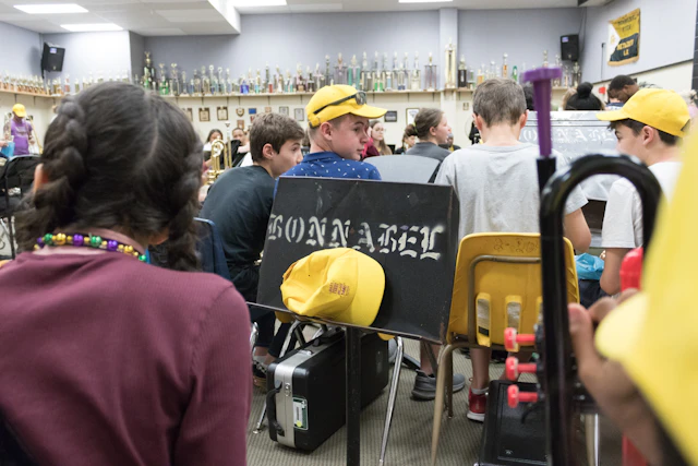 School band students practicing with instruments in a music classroom
