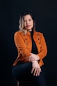 A woman sitting on a chair with her legs crossed