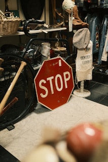 A red stop sign sitting on top of a floor