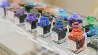 A row of different colored nail polish bottles