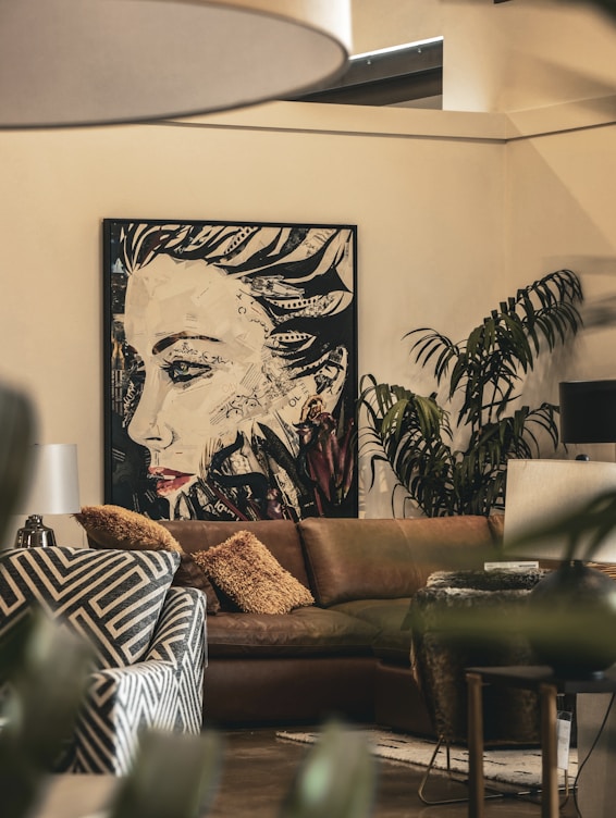 A living room filled with furniture and a painting on the wall