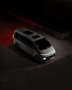 A white van parked in a parking lot at night