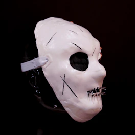A white mask with black lines on it