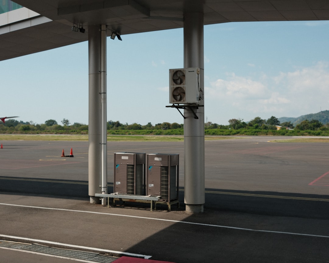 A gas station with a gas pump on the side of the road,