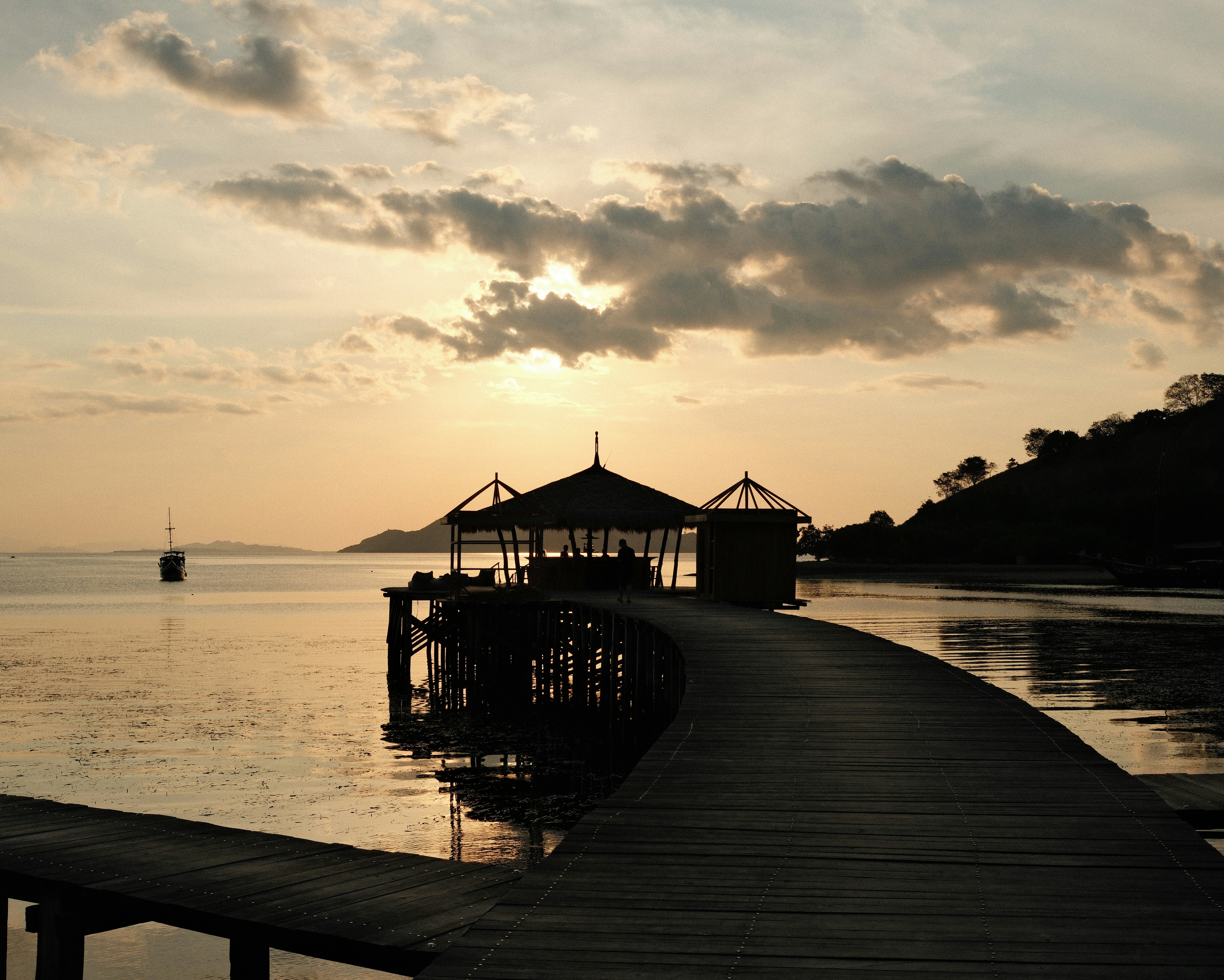 A pier with a gazebo in the middle of a body of water