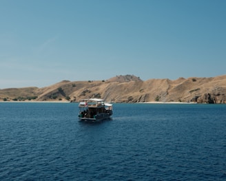 A small boat in the middle of a large body of water