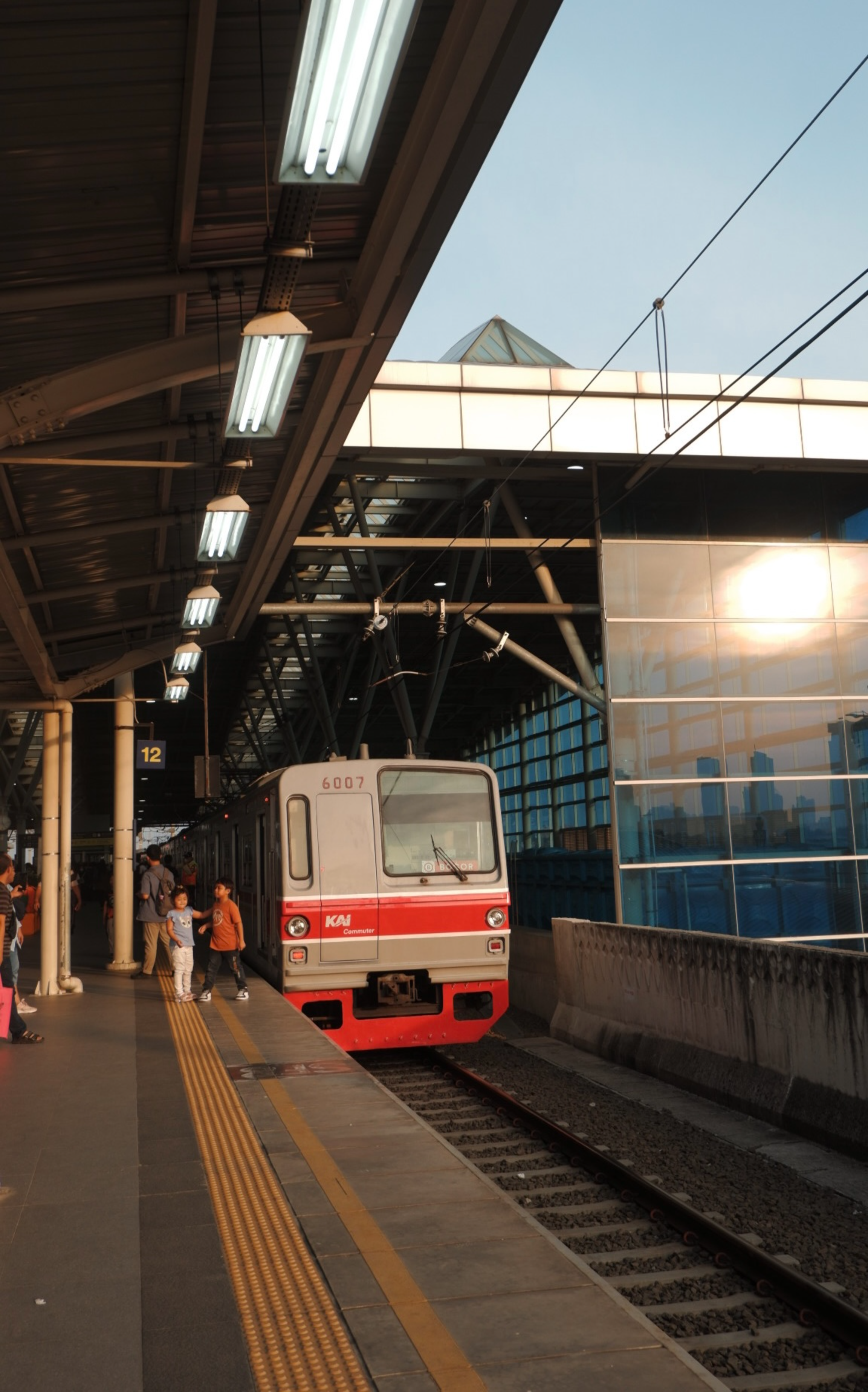 A red and white train pulling into a train station