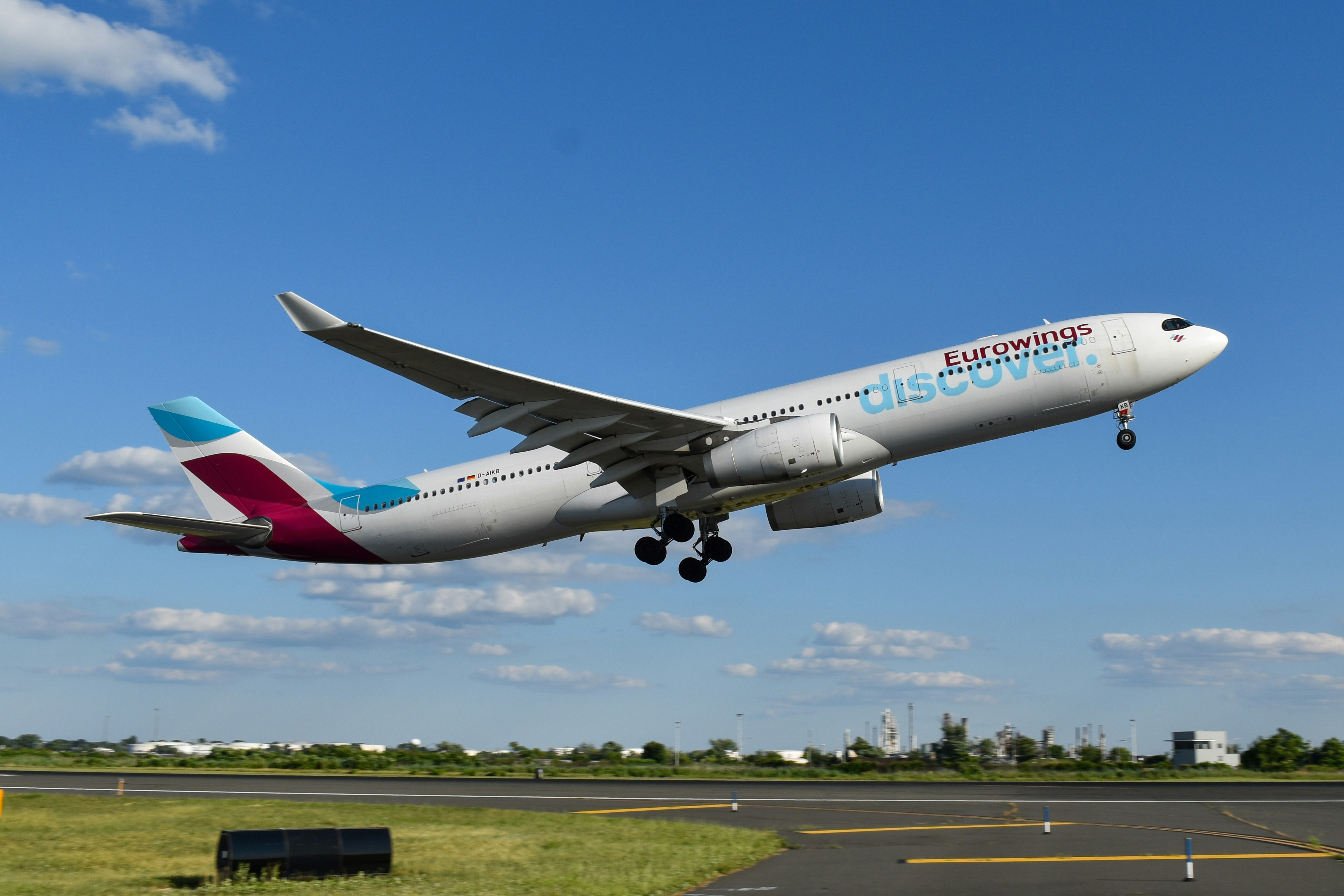 A large passenger jet taking off from an airport runway, Discover Airlines A330 departing Philadelphia