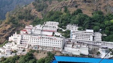 A large white building sitting on the side of a mountain
