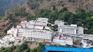 A large white building sitting on the side of a mountain