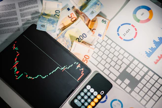 A calculator sitting on top of a pile of money
