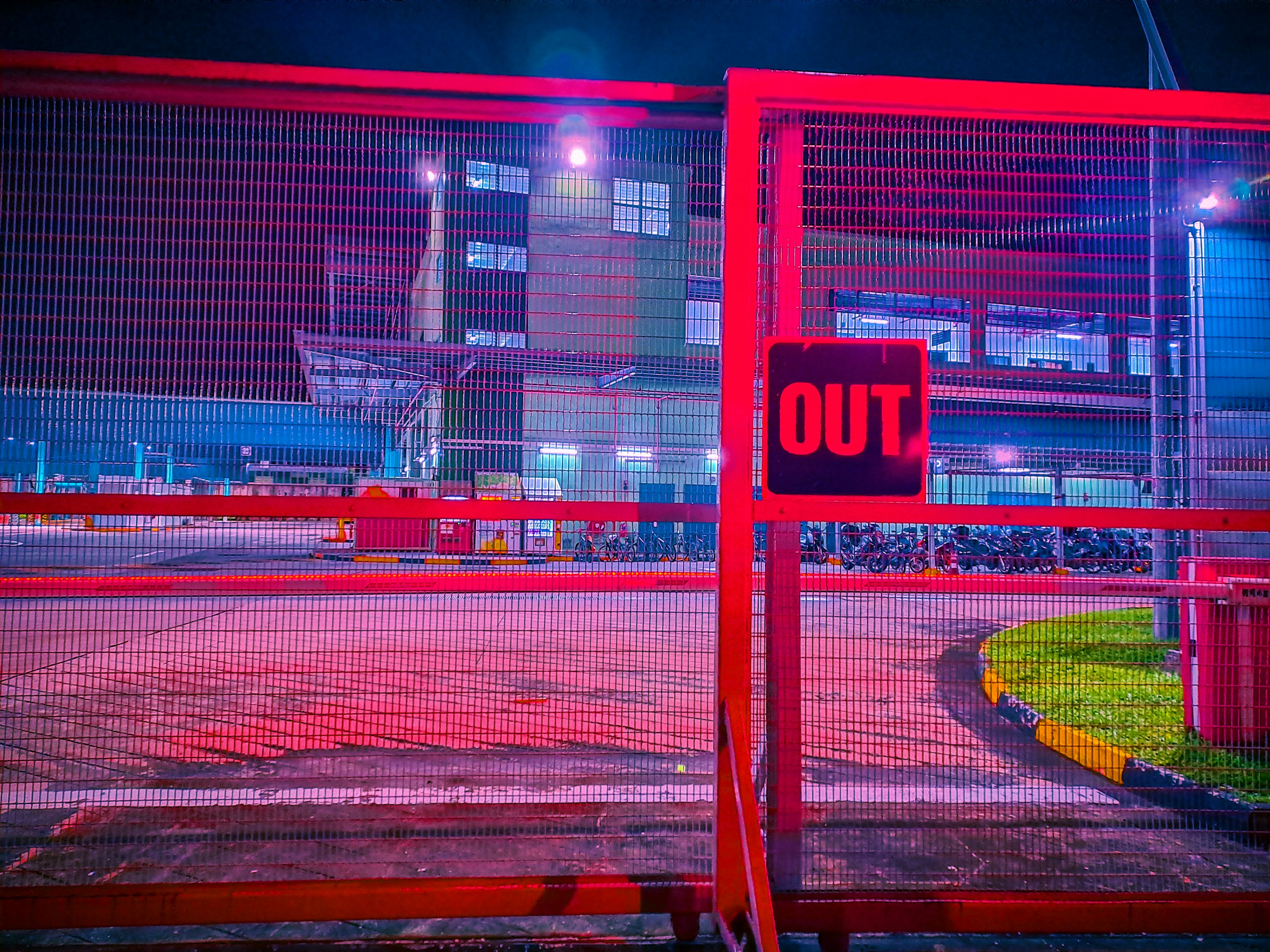 A red gate with a sign that says to do