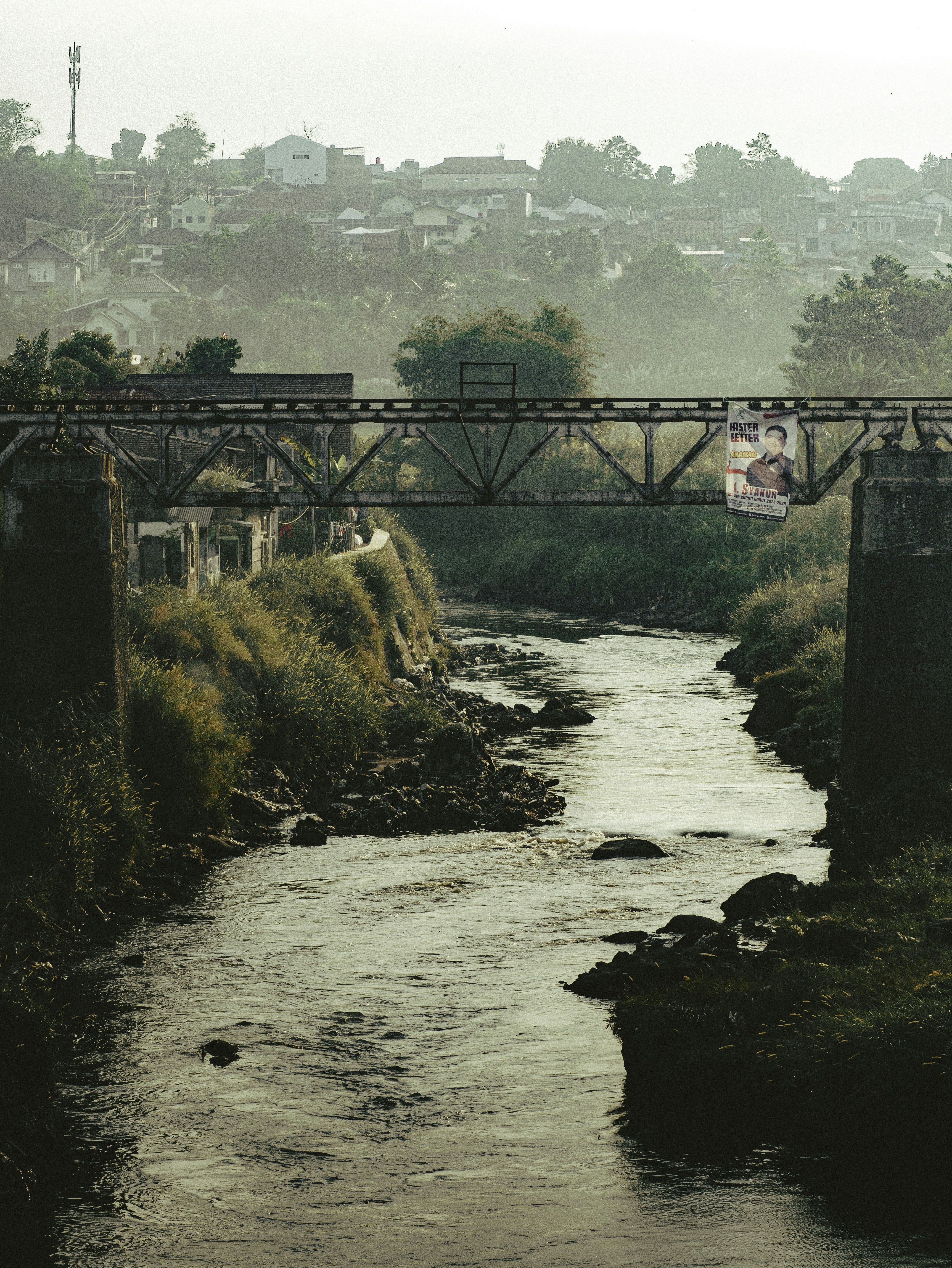 A river running through a lush green countryside
