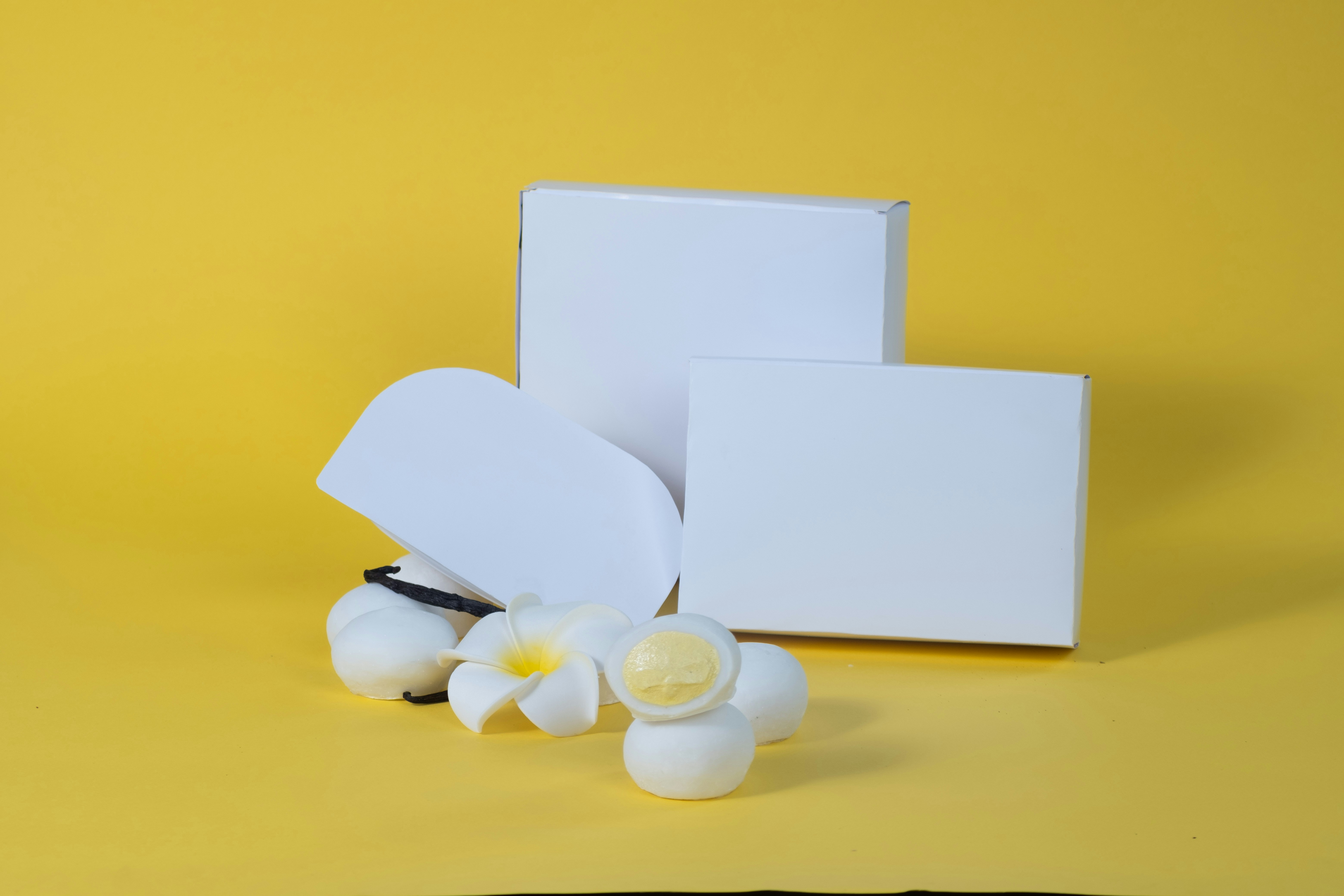 A couple of white flowers sitting on top of a table