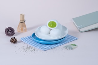 A white plate topped with eggs next to a book