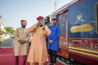 A group of men standing next to a train
