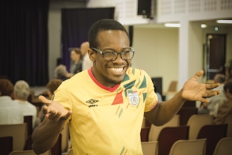A man in a yellow shirt standing in front of a crowd