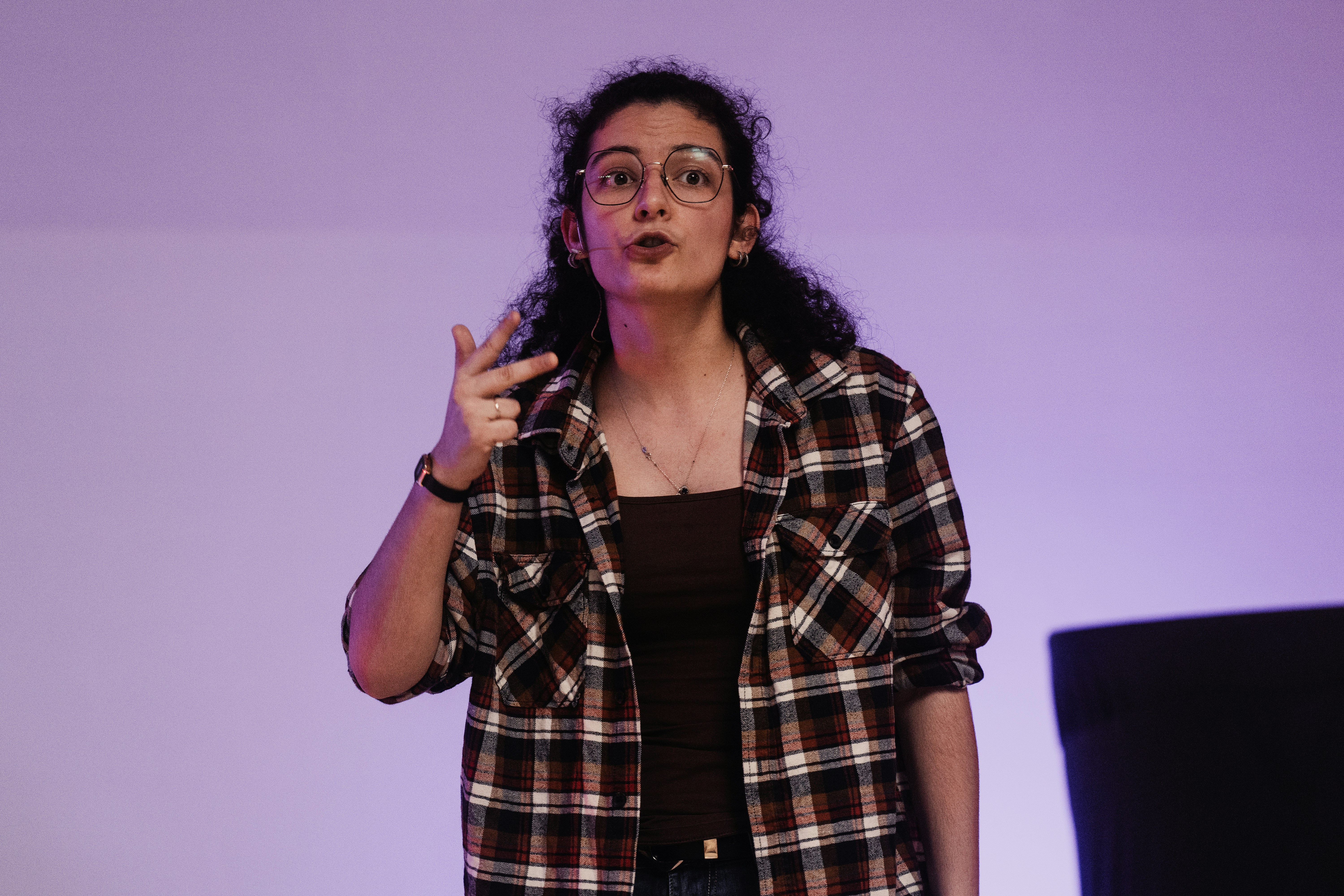 A woman standing in front of a projection screen