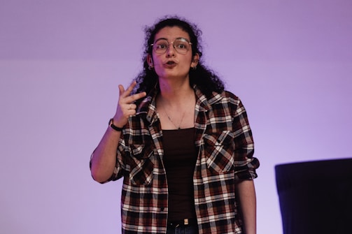 A woman standing in front of a projection screen